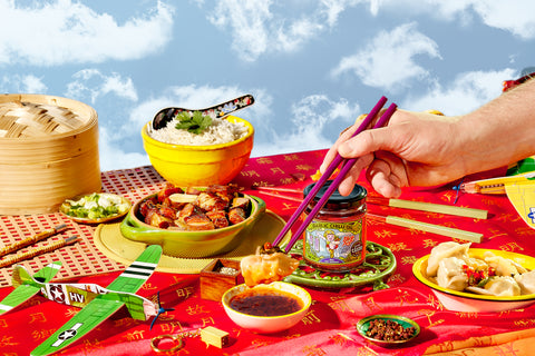 Dipping a dumpling into Yep Kitchen Garlic Chilli Oil with Beef using chopsticks